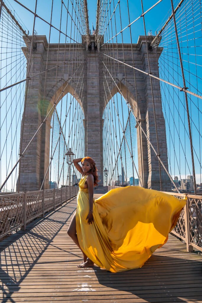 gold flying dress photoshoot at the Brooklyn Bridge in New York