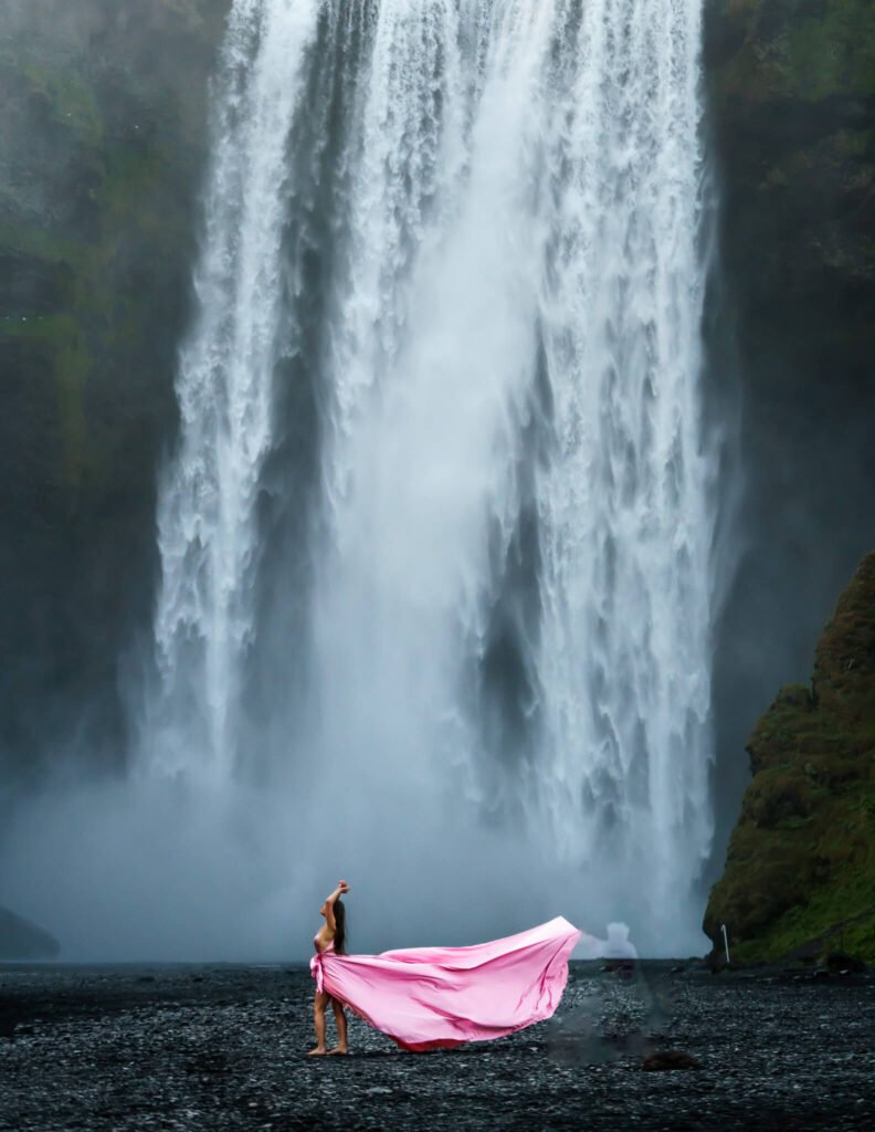 Flying dress photoshoot iat a waterfall in Iceland