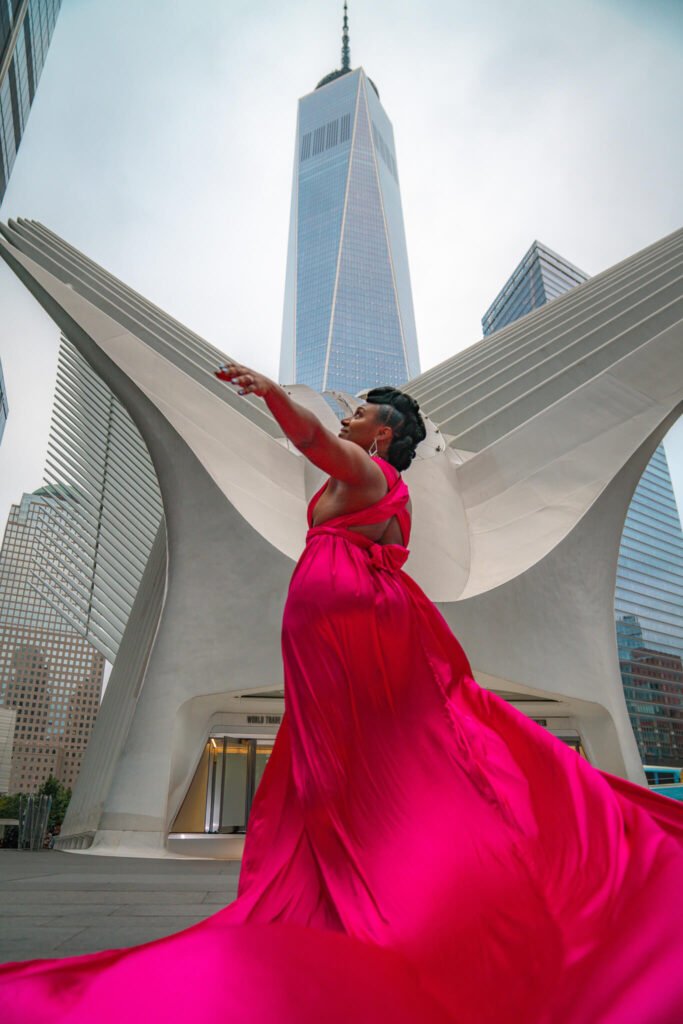girl in a flying dress outside the Oculus of NYC