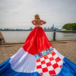 girl in a Croatia flag flying dress in front of the NYC skyline