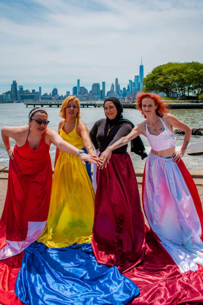 Group B of the World Cup flag flying dress photoshoot in front of the NYC skyline