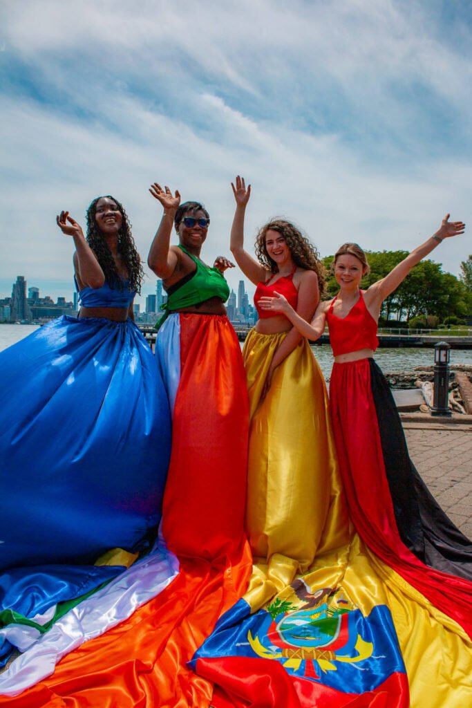 Group E of the World Cup flag flying dress photoshoot in front of the NYC skyline