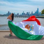 Mexico flag flying dress in front of the NYC skyline