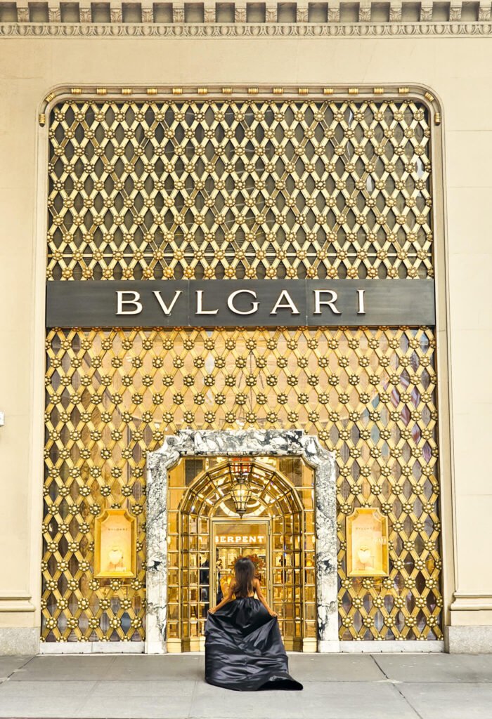 girl in a black flying dress doing a flying dress photoshoot in front of Bvlgari NYC