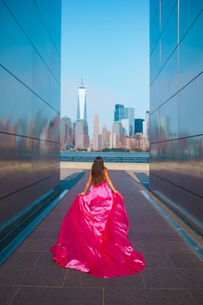 girl in a hot pink flying dress at the Empty Sky memorial in Liberty State Park, New Jersey